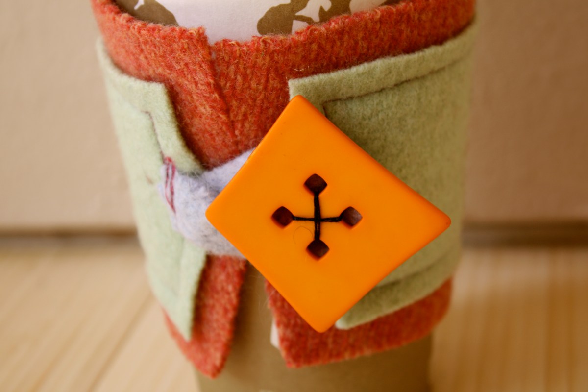 Plaidypus orange and green felted wool coffee cup cozy with bright orange button